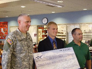 In August, Col. Michael Curry, USA (l), chapter president, and Ares Koumis (r), Science Fair Committee chairman, present a check to Ethan Hahn, the Grand Prize winner of the AFCEA National High School Science Fair.